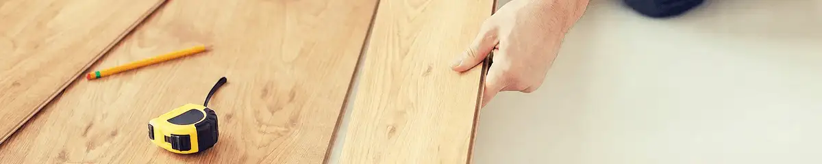 A professional installing wood flooring in Staten Island, NY