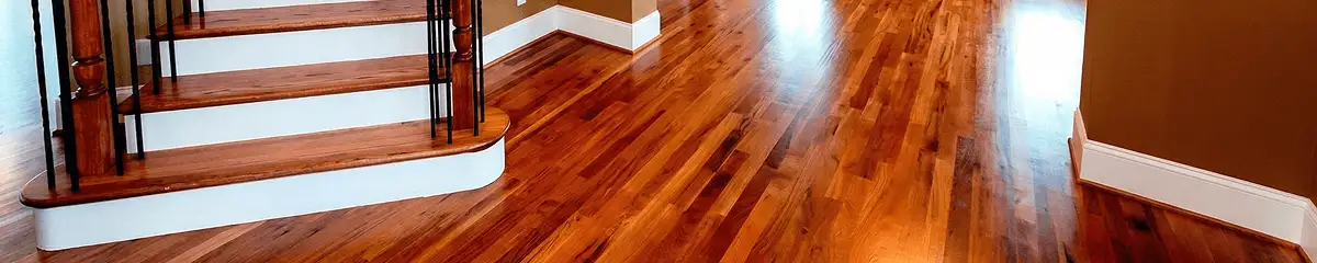 Base floor of a staircase with professionally restored wood flooring in Staten Island NY