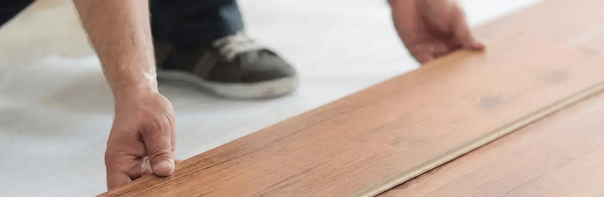 A professional installing laminate flooring in Staten Island, NY