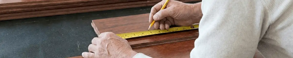 A professional installing wood flooring in Staten Island, NY
